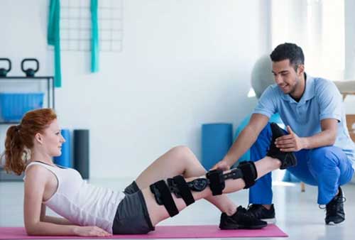 A physical therapist working with a patient