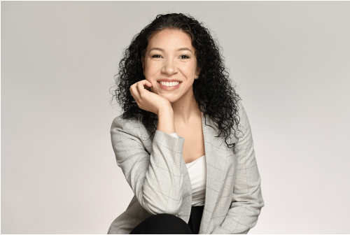Adelita Aguirre in a gray blazer against a gray background.